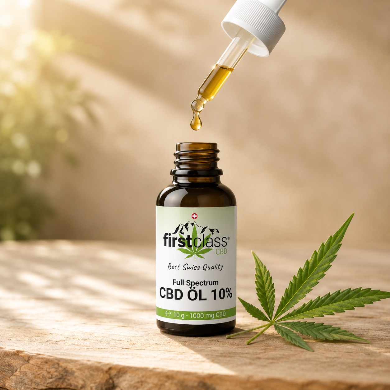First Class CBD Öl 10 % mit Glaspipette und Hanfblatt auf heller Holzoberfläche